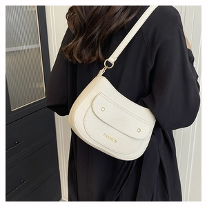 Detail of cream white pebbled leather bag with gold buckle and Fashion lettering
