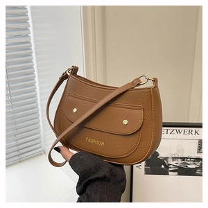 Close-up of brown litchi pattern shoulder bag featuring golden buckles and fashion logo