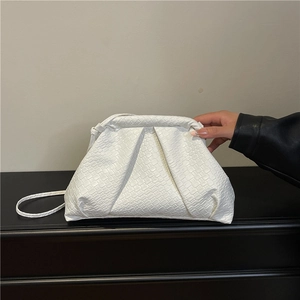 White cloud-shaped woven shoulder bag with a soft pleated texture and slim strap