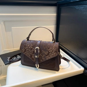 Vintage dark brown crossbody bag with snake texture and gold horseshoe buckle details
