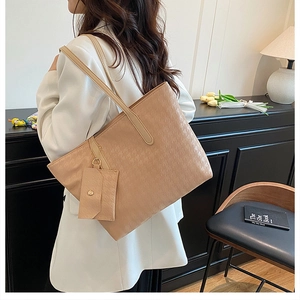 Chic beige houndstooth tote bag shown with a small matching pouch on a fashion model