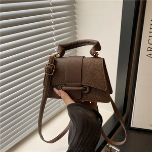 Mini dark brown pebbled leather crossbody bag with top handle and metal ring flap closure
