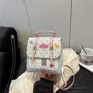Mini white polka dot backpack with pink handles and creative patches for daily use