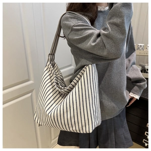 Detail view of large capacity tote bag with classic blue and white vertical stripes