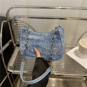 Light blue denim hobo bag with silver chain strap and shoulder strap in urban style