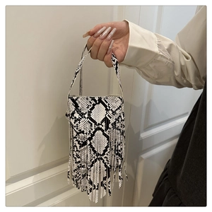 Detail of snake print crossbody bag with fringe tassels and leather texture finish
