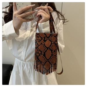 Detailed shot of brown snakeskin pattern phone bag with long tassels and thin strap