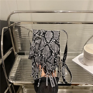 Chic snakeskin print crossbody bag with long tassels and silver buckle strap