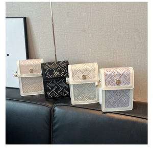 Detail of four embroidered crossbody bags with floral patterns and gold flower metal clasps