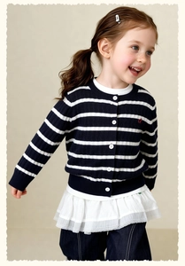 Detail of navy and white striped girls' knit cardigan with red embroidery and white buttons