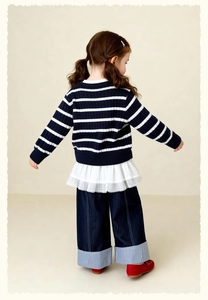 Detail of girls striped knit sweater with lace trim and denim wide-leg trousers set