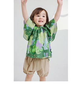 Detail of girl's summer cotton set featuring floral print top and khaki puff shorts