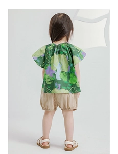 Back view of girl in forest print shirt and beige puff shorts cotton linen set