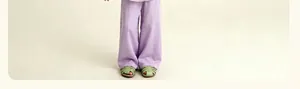 Détail du pantalon large enfant violet clair avec plis centraux et sandales tissées