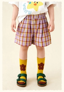 Détail d'une tenue d'été pour filles avec t-shirt à étoile et short à carreaux