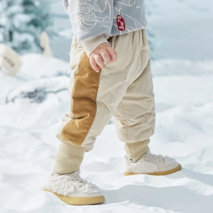 Kinder donsbroek met corduroy patchwork en geribde boorden in sneeuwlandschap