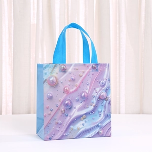 Close-up of shell pattern gift bag with blue handles and gradient bubble prints