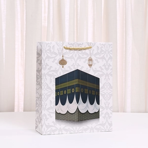 Kraft paper gift bag with Kaaba illustration and golden rope handles for Ramadan
