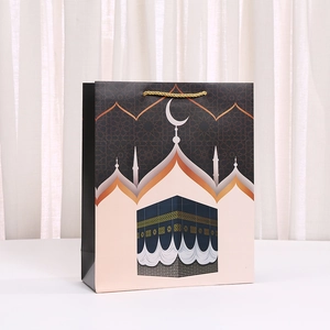 Detail of Middle Eastern architecture paper gift bag with golden braided rope handles