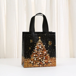 Black non-woven Christmas gift bag with golden tree print and sturdy fabric handles