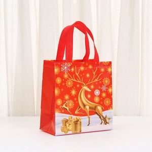 Festive red Christmas gift bag with golden reindeer pattern and reinforced handles