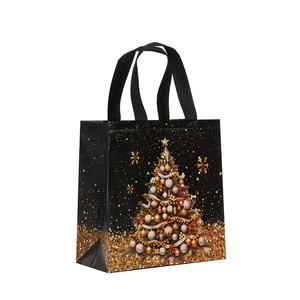 Elegant black non-woven Christmas gift bag with golden festive tree prints in 45-degree view