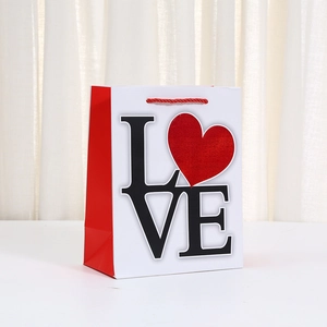 Valentine's Day kraft paper gift bag with red LOVE heart print and woven handles