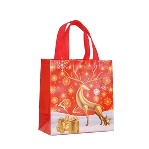 Red Christmas non-woven gift bag with golden reindeer and snowflake patterns