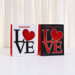 Black and white kraft paper gift bags with red LOVE heart and braided handles
