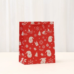 Red Christmas Santa Claus gift paper bag with white snowflake patterns and rope handles