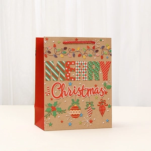Christmas kraft paper gift bag with red handles and Merry Christmas festive print