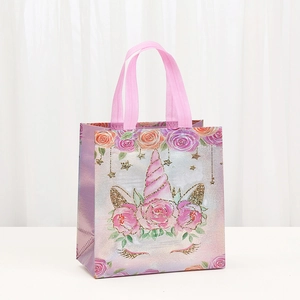 Unicorn themed non-woven gift bag with floral prints and pink handles for party packaging