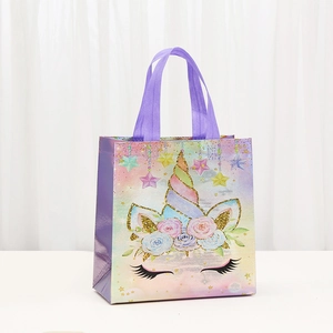 Unicorn non-woven gift bag with rainbow gradient, floral details and glitter finish