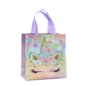 Holographic unicorn non-woven gift bag with pastel floral patterns and purple handles