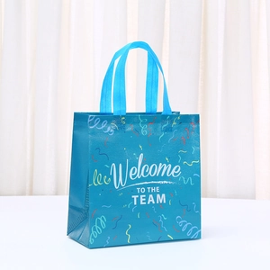 Détail du sac cadeau bleu en non-tissé avec inscription Welcome TO THE TEAM et rubans