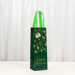 Green non-woven Christmas wine bag with gold Merry Christmas print and handles