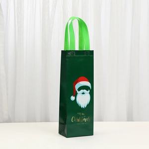 Close-up of non-woven Christmas wine bag with Santa Claus print and Merry Christmas text
