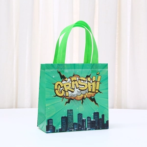 Detail of green non-woven tote bag with yellow Crash comic text and city silhouette