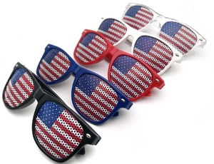 Detail of five colored party sunglasses with American flag pattern lenses and honeycomb holes