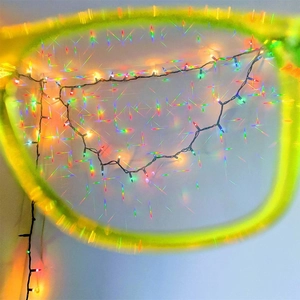 Close-up of fireworks diffraction glasses lens with vibrant rainbow starburst light effects