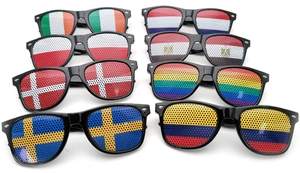 Flat lay of diverse national flag lens stickers on black party sunglasses frames