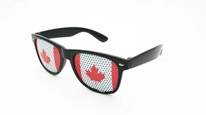 Close-up of Canada flag pattern on pinhole lenses with black plastic frame sunglasses