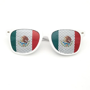Detail of white party sunglasses featuring perforated Mexican flag patterns on lenses