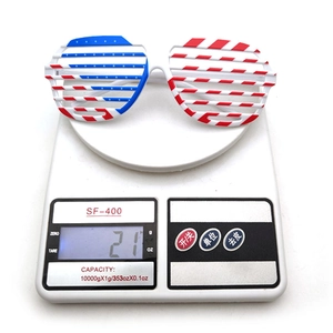 Detailed view showing the American flag shutter glasses weighing 21 grams on a digital scale