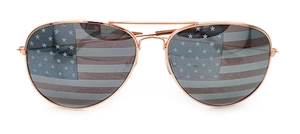Detail of rose gold aviator sunglasses with USA flag pattern on lenses for parties