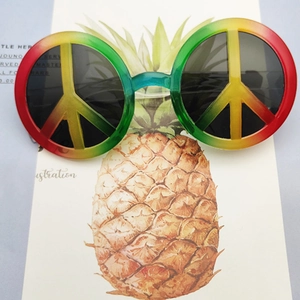 Macro detail of round rainbow gradient sunglasses featuring a peace sign on pineapple card