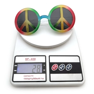Close-up showing the lightweight 28g weight of peace sign hippie sunglasses on a scale