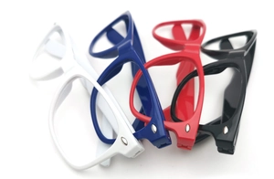 Detail of colorful plastic sunglasses frames in white, blue, red and black without lenses