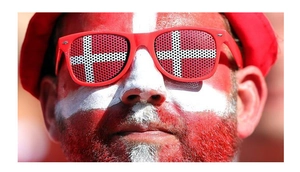 Detail of red party sunglasses with Danish flag pinhole lenses for sports events