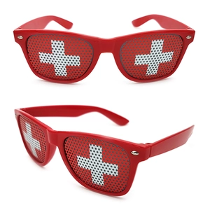 Detail view of red frame sunglasses featuring Swiss flag pinhole lenses for parties